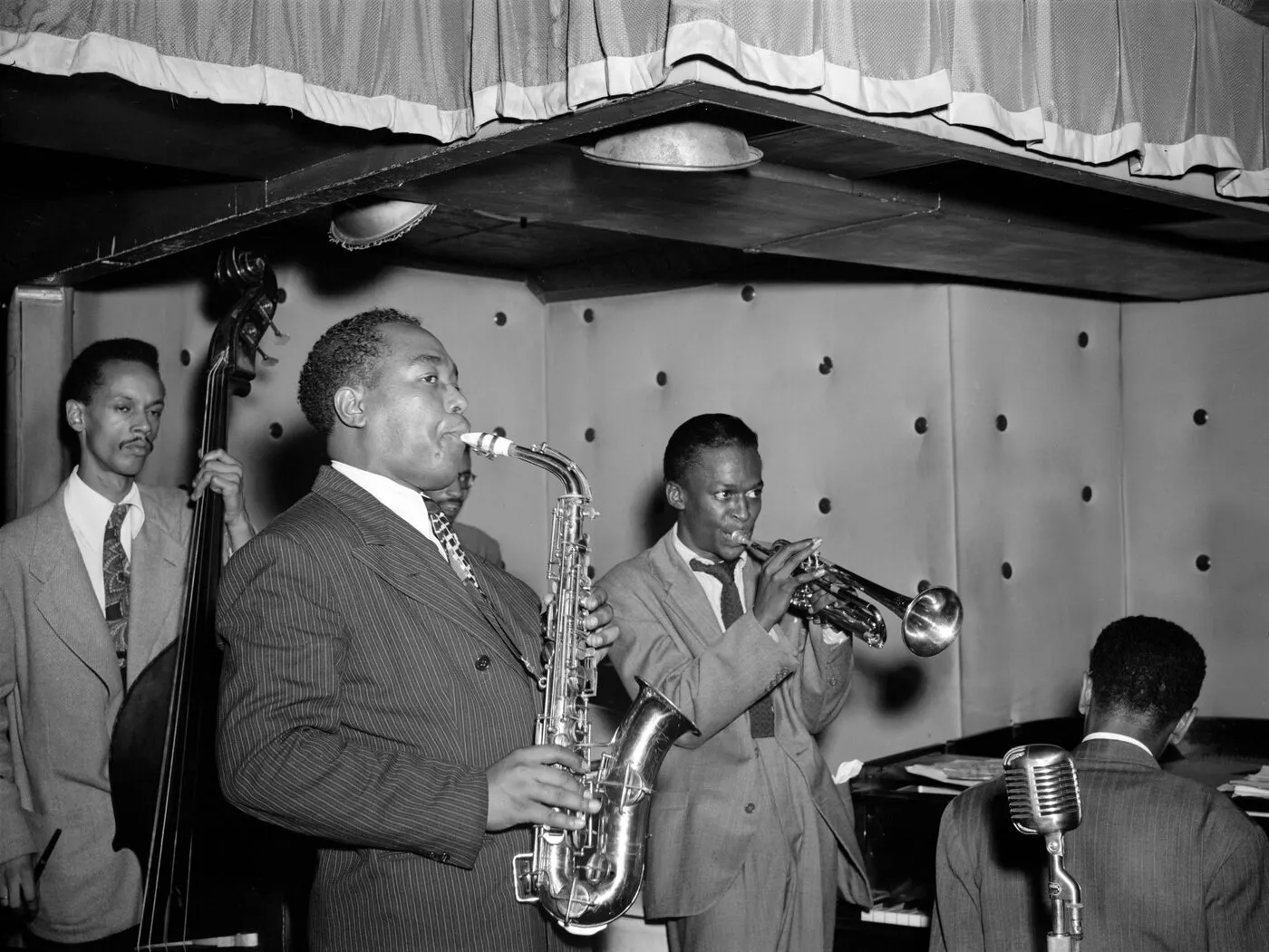 Miles Davis performing with Charlie Parker and other musicians at the Three Deuces
