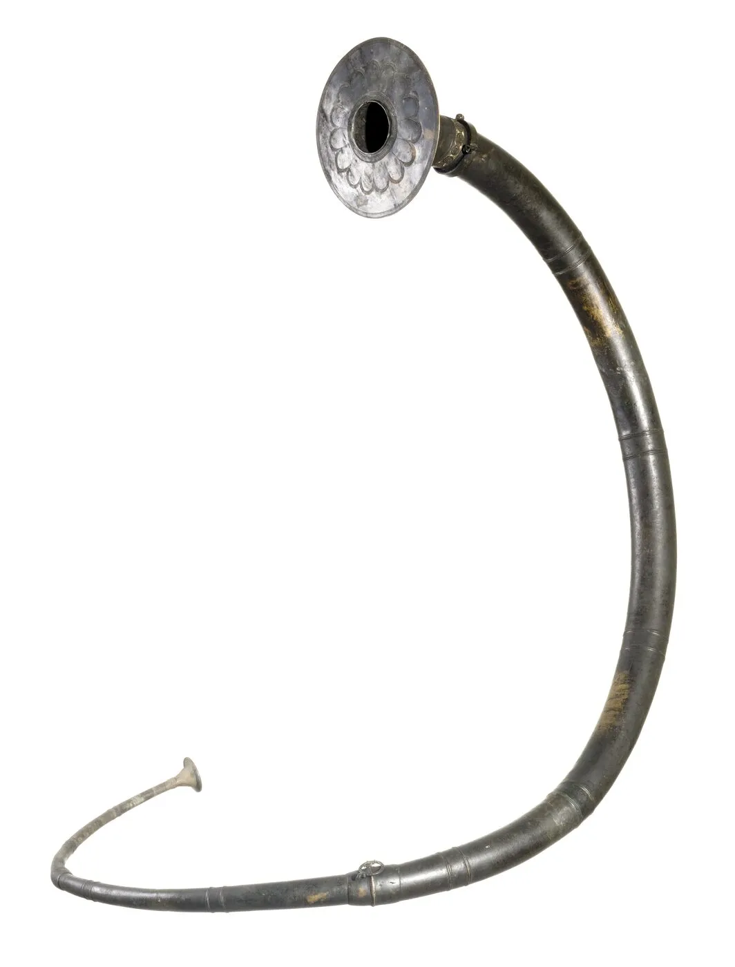 A Bronze Age bronze lur with a long curved tube and broad end plate