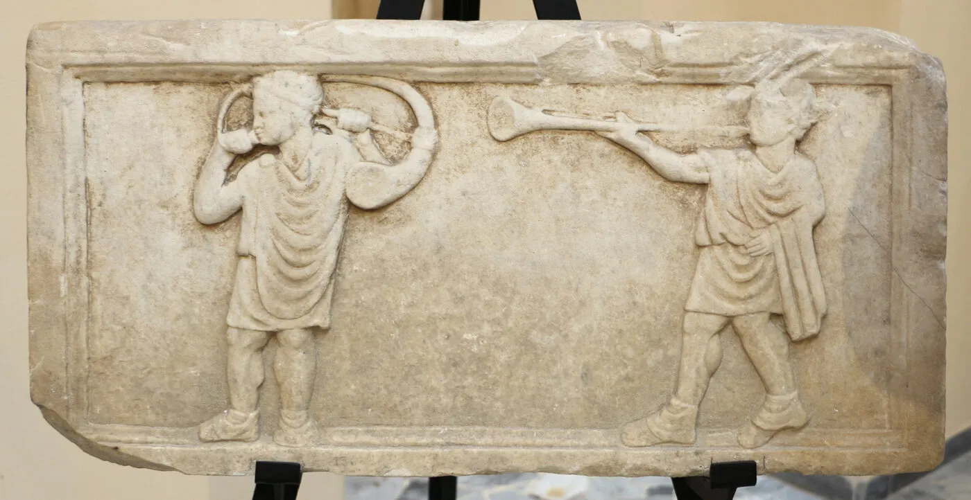 Roman relief showing musicians playing a curved cornu on the left and a straight tuba on the right