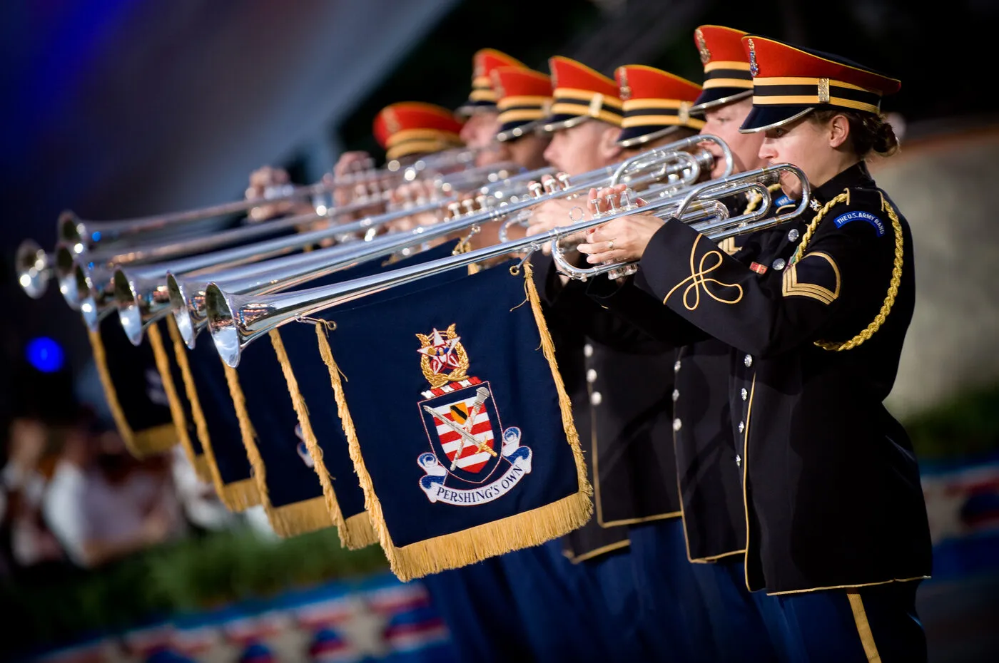 Herald trumpeters performing with banners hanging from their long bell sections