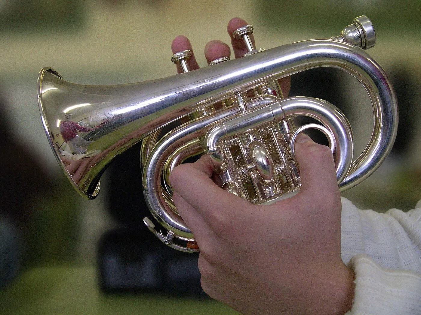 Pocket trumpet held in one hand